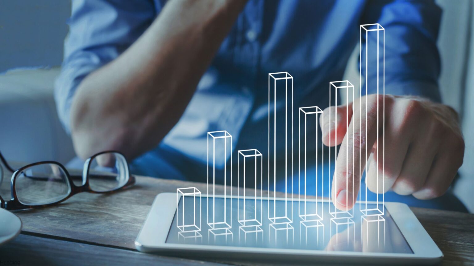 Photo illustration of a person manipulating a 3D bar graph