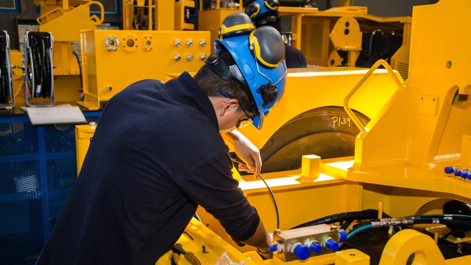 Worker operating manufacturing equipment