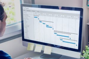 Businessman looking at an onscreen flow chart