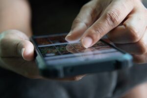 Hands making a selection on a mobile touchscreen