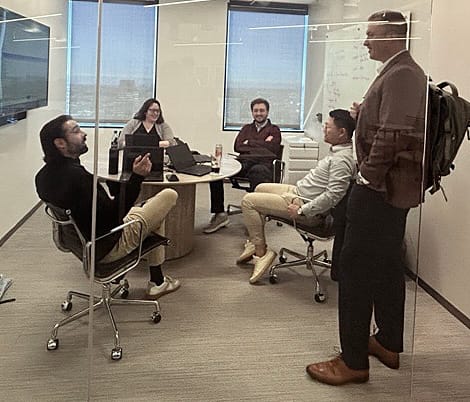 Team members meeting in a closed conference room
